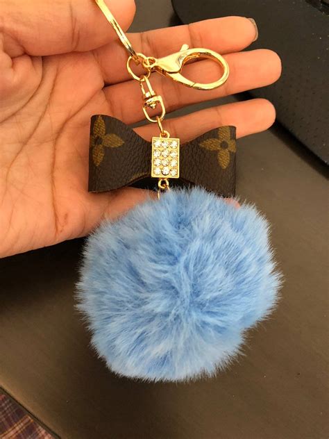 pom pom keychain louis vuitton|louis vuitton luggage charm.